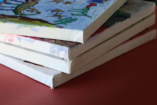 A selection of canvas paintings stored flat for protection