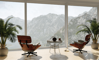 Two wooden chairs looking out to a view of mountain peaks