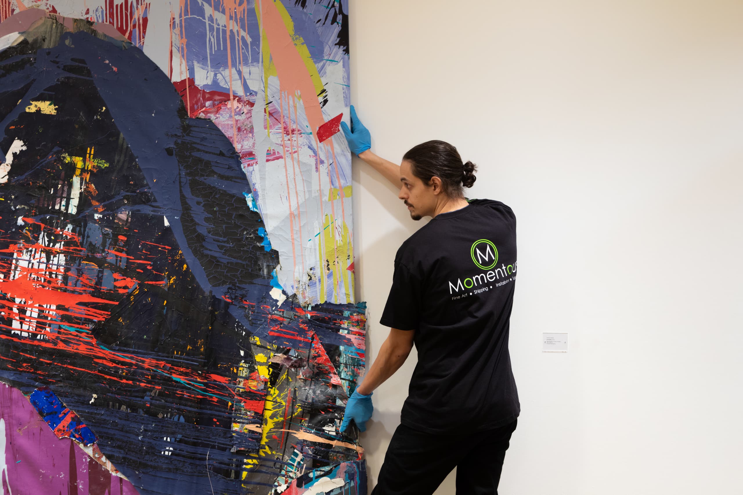 Momentous Relocation employee moving a painting.