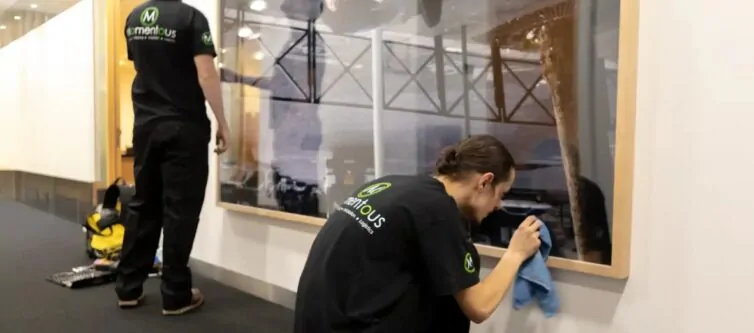 Momentous Relocation team polishing hanging artwork.