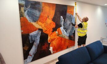 Momentous Relocation worker measuring a piece of artwork.