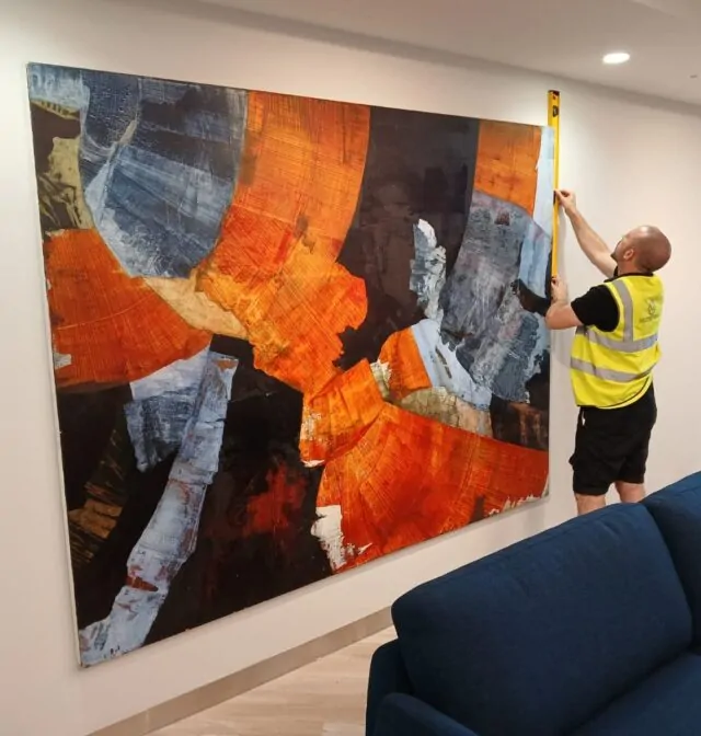 Momentous Relocation worker measuring a piece of artwork.
